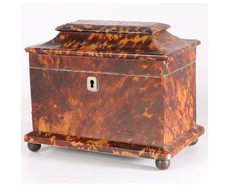 A 19th century tortoiseshell tea caddy, having a angled lid opening to reveal two lidded compartments with ivory edges, with 
