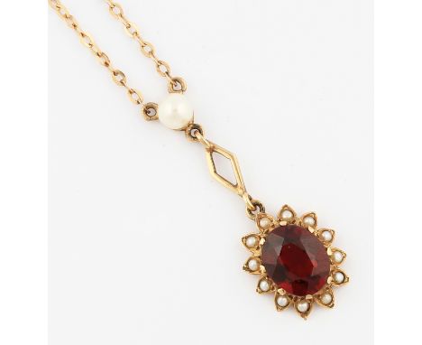 A garnet and seed pearl necklet, set with an oval cut garnet, surrounded by a border of seed pearls set in flower head design