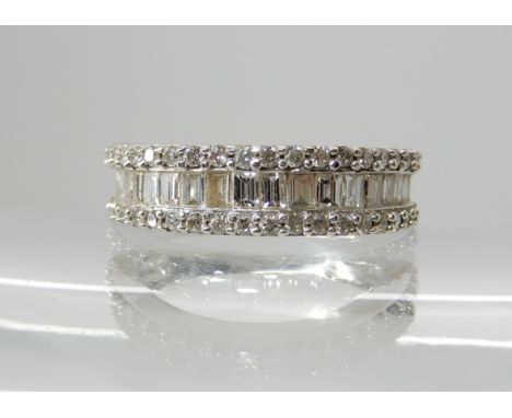 An 18ct white gold brilliant and baguettes cut diamond cluster ring of estimated approx 1ct, finger size M, weight 4.2gms Con