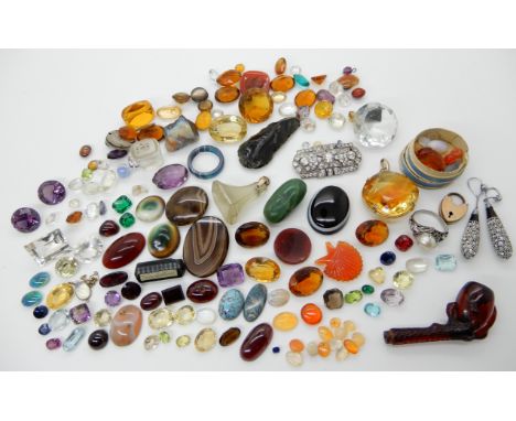 A collection of loose gemstones to include fire opals, tourmaline, garnets, citrines and a cherry amber coloured pipe in the 