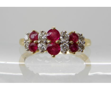 An 18ct gold ruby and diamond ring, diamonds are estimated approx at 0.25cts, finger size O1/2, weight 3.2gms Condition Repor