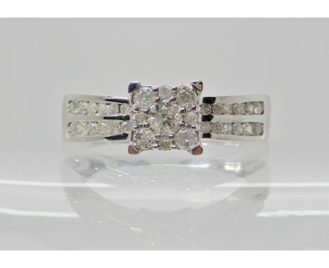 A 9ct white gold diamond cluster ring set with estimated approx 0.50cts of brilliant cut diamonds, size Q, weight 3.4gms Cond