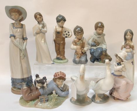 A Lladro figure of a boy and dog and nine Nao figures of Children (10) Condition Report: Available upon request