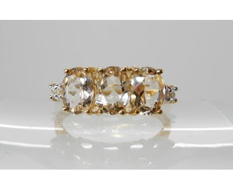 A three yellow sapphire and diamond ring, size of sapphires approx 7mm x 5mm, finger size Q, weight 2.6gms Condition Report: 