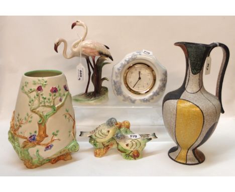 An Italian pottery jug, 28cm high, a Lladro mantel clock, 14cm high, a Clarice Cliff vase, 20.5cm high, a Keramos figure of t