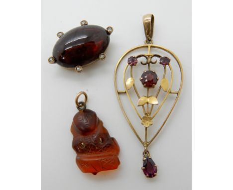 A 9ct gold garnet set Edwardian pendant, dimensions 4.7cm x 2cm, a garnet and rose cut diamond item and a yellow metal mounte