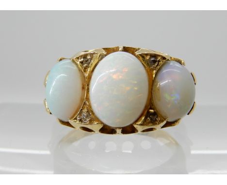 A bright yellow metal opal and diamond ring, largest opal approx 8.9mm x 6.9mm, finger size K, weight 5gms Condition Report: 