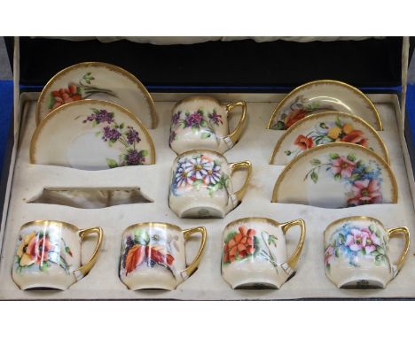 A boxed set of Nautilus cups and saucers, handpainted with flowers (one saucer missing) Condition Report: Available upon requ