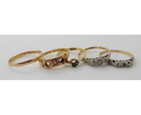 Two 18ct gold diamond rings, an 18ct gem set ring, an 18ct gold ring mount and an 18ct gold wedding ring (all as found) weigh