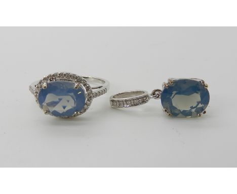 A 9ct white gold blue opal and diamond ring, finger size N1/2, with matching pendant, length 2.8cm, weight combined 4.6gms Co