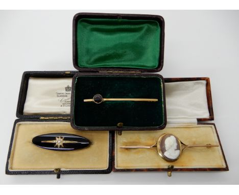 A yellow metal mounted onyx and pearl star mourning brooch, 4.5cm, a 9ct gold shell cameo bar brooch 7.7cm and a 9ct gold gar