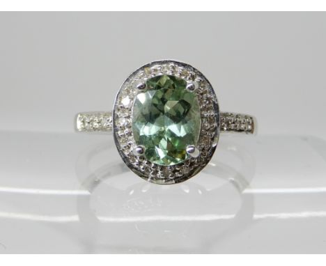 An 18ct white gold tourmaline and diamond ring, tourmaline approx 8mm x 6mm, finger size N1/2, weight 3.3gms Condition Report