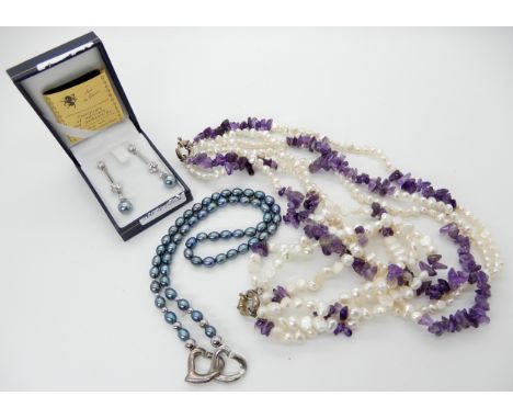A triple strand of amethyst and pearls with a silver clasp, with matching bracelet, black pearls with matching faux pearl ear