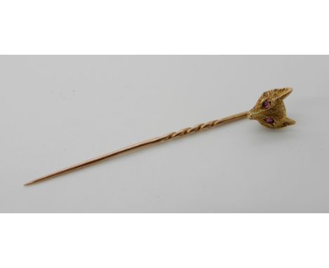 A bright yellow metal fox pin with ruby set eyes, length 5.5cm, weight 1.9gms Condition Report: Available upon request