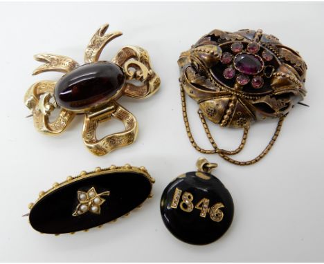 A yellow metal garnet set locket back bow brooch 4.7cm x 4.2cm, a yellow metal Victorian garnet flower set locket back brooch