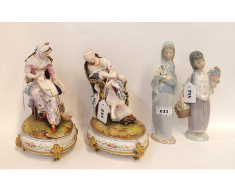 Two French figural bisque porcelain boxes, each with a woman seated on a chair, 22cm high, (slight def), and two Lladro figur