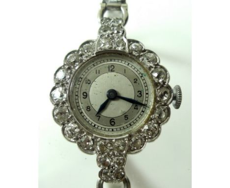 A lady's Art Deco platinum and diamond cocktail watch, the platinum case encircled with fourteen diamonds each of approximate