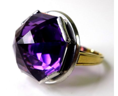 An amethyst dress ring, the unusual and large octagonal step cut amethyst of approximately 16.38mm in a high ring mount of wh