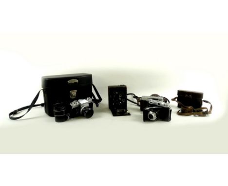 A group of four cameras, comprising vintage Lonar folding box camera, a/f missing back, 14cm high, a Balda collapsible lens c