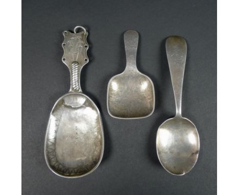 A collection of three silver caddy spoons, comprising a Dutch 19th century example, the handle engraved with a vase of flower