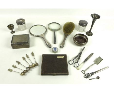 A collection of Edwardian and later silver and white metal items, including a mirror and brush, both 27cm long, magnifying gl