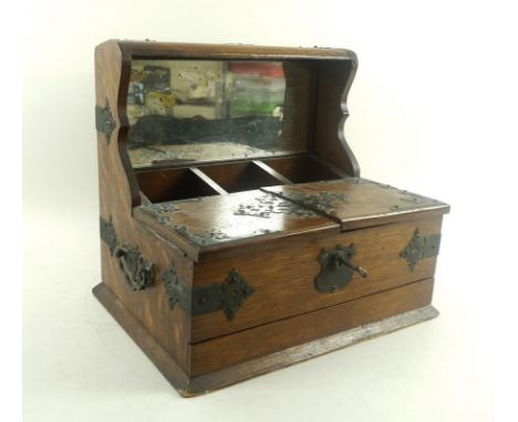 A Victorian oak tantalus, with games drawer, mirrored back and presentation plaque to 'Primo George M. J. Mitchell from the G