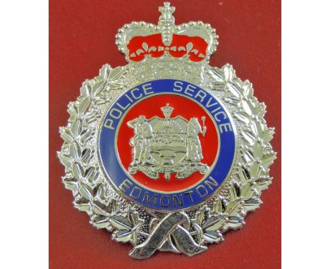 Edmonton Police Service cap badge, white metal with enamel facings. Good condition with screw back pins.
