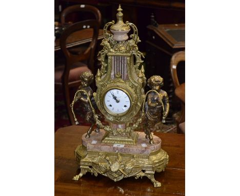 A Louis XVI style gilt metal and rouge marble mantel clock, the white dial inscribed Imperial, Roman numerals, the lyre shape