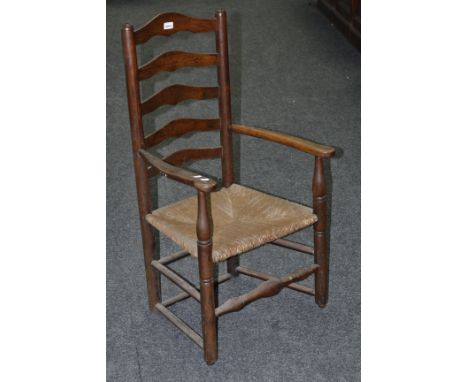 A country ladder back chair, outswept open arms, rush seat, turned stretchers; an oak bedroom chair, pierced splat, rush seat