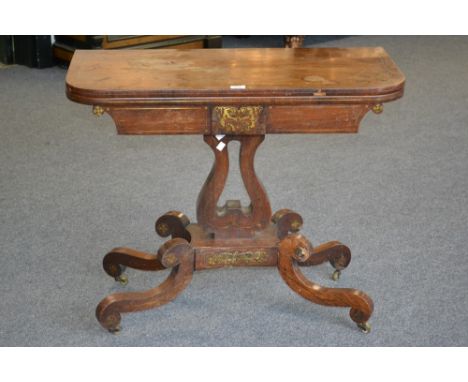 A Regency mahogany brass inlaid card table, rounded square top opening to green baize playing surface, lyre shaped support, q