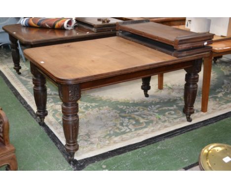 A Regency mahogany wind out dining table, rounded rectangular top, acanthus carved, turned and fluted legs, ceramic casters, 