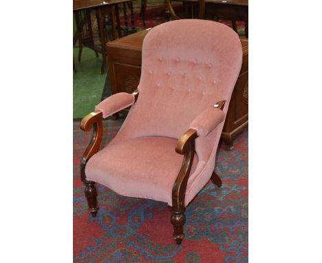 A Victorian button back open arm chair, padded arms, stuffed over seat, turned forelegs, ball bearing  casters.C1880