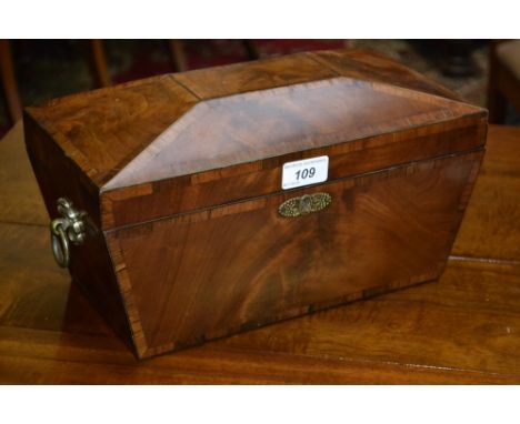 A Regency rosewood crossbanded mahogany sarcophagus tea caddy, hinged cover enclosing a bowl flanked by a pair of lidded comp