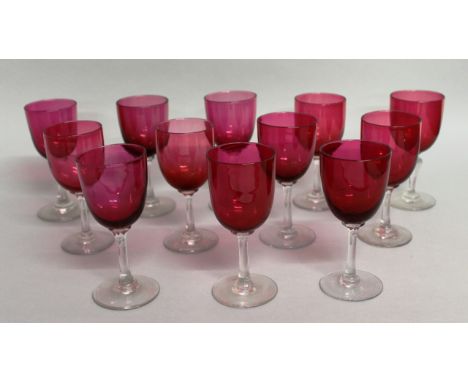 A NEAR MATCHING SET OF TWELVE RUBY GLASS WINE GLASSES. 