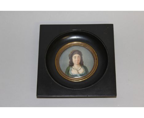 A CIRCULAR PORTRAIT MINIATURE of a TURKISH LADY wearing a green head band. 2.5ins diameter. 