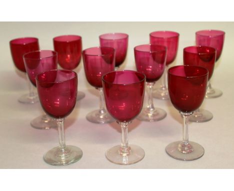 A NEAR MATCHING SET OF TWELVE RUBY GLASS WINE GLASSES. 