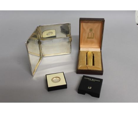 A DUNHILL ENGINE TURNED GILT LIGHTER, in box, a CHROME DUNHILL CIGARETTE CASE and a DUNHILL COIN, YES & NO, in box. 