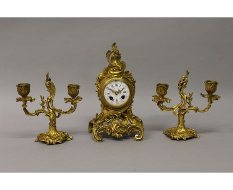 A SMALL 19TH CENTURY FRENCH THREE PIECE CLOCK SET, the clock with eight day movement, white enamel dial and blue and white Ro