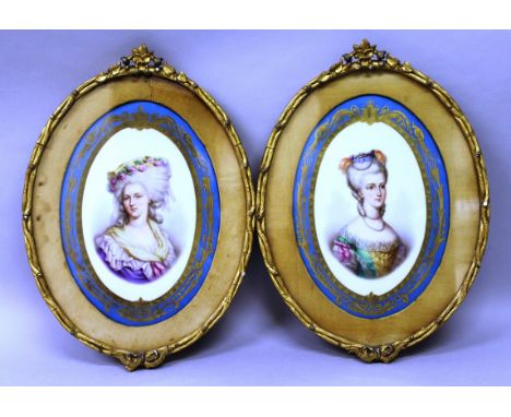 A GOOD PAIR OF FRAMED 19TH CENTURY SEVRES OVAL PORCELAIN PLAQUES, portrait studies, head and shoulders of two ladies in a ric