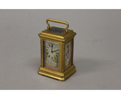 A MINIATURE FRENCH SEVRES STYLE CARRIAGE CLOCK with four painted porcelain panels. 3.25ins high. 