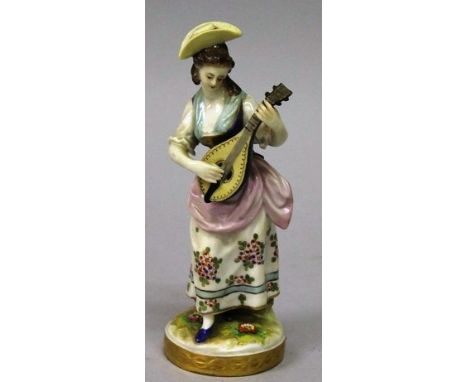 A FIGURE OF A WOMAN playing a mandolin, a lamb at her side and a man carrying a basket of flowers. 6.5ins x 7.5ins high. 