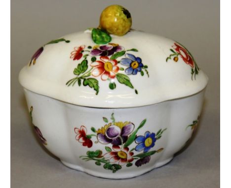 AN 18TH CENTURY DOCCIA SUCRIER AND COVER with tin glaze painted with flowers, the cover with a lemon finial. 