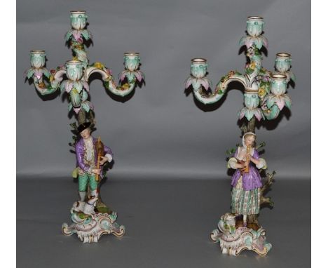 A GOOD PAIR OF 19TH CENTURY MEISSEN CANDELABRA, CIRCA. 1850, the bases with a young gallant and lady both playing musical ins