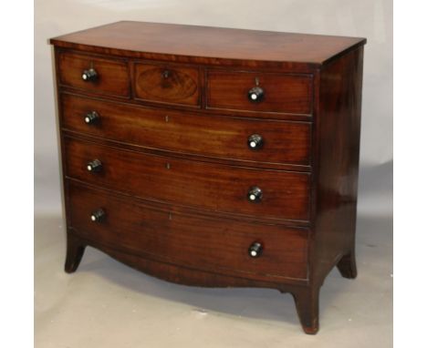 AN EARLY 19TH CENTURY MAHOGANY BOWFRONT CHEST OF DRAWERS, with three small drawers over three graduated long drawers with tur
