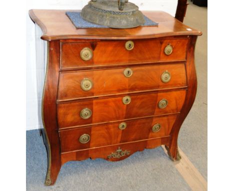 AN 18TH CENTURY DUTCH FLAME MAHOGANY BOMBE FRONTED COMMODE with serpentine shaped front, fitted with four long graduated draw
