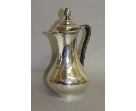 A GEORGE III PEAR SHAPED HOT WATER JUG with leather bound handle and pineapple finial. London 1766. Maker C. W. & T. W. Weigh