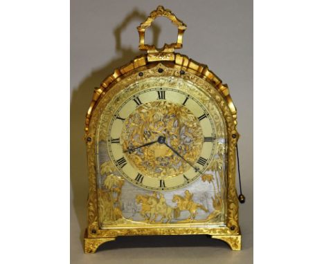 A SUPERB STRUTT CLOCK with finely engraved case, the dial pierced with foliage, palm trees and a hunting scene. 7ins high. 