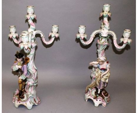 A GOOD PAIR OF DRESDEN STYLE FOUR LIGHT CANDELABRA, each with three scrolling branches on tree like supports with a gallant a