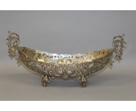 A GOOD LARGE CONTINENTAL TWO HANDLED BOAT SHAPED BASIN with repoussé decoration on four pierced feet. Stamped .835. Weight 28