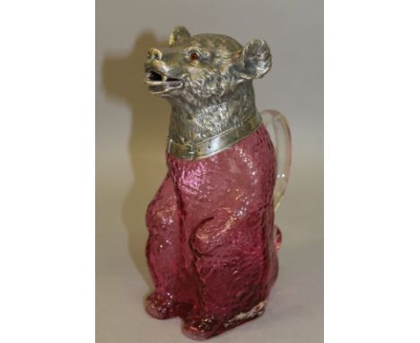 A GOOD NOVELTY PLATE MOUNTED SEATED BEAR CLARET JUG with ruby glass body. 8.5ins high. 